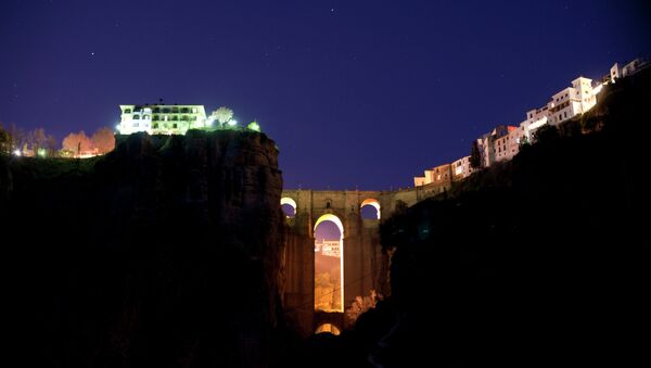 The New Bridge of Ronda is enlightened from behind during the global climate change awareness campaign Earth Hour, on March 28, 2015 - Sputnik International