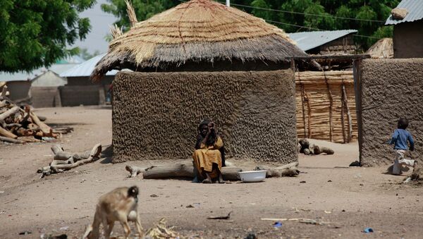 Woman sits outside her home in Chibok, Borno - Sputnik International