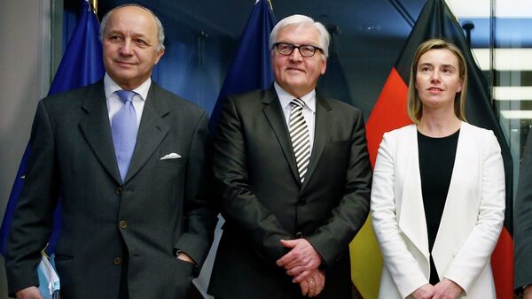 France's Foreign Minister Laurent Fabius (L-R), Germany's Foreign Minister Frank-Walter Steinmeier, European Union foreign policy chief Federica Mogherini pose ahead of nuclear talks in Brussels March 16, 2015 - Sputnik International