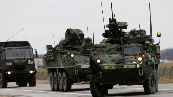 Stryker vehicles of the US Army’s 2nd Cavalry Regiment roll down the way during the ''Dragoon Ride'' military exercise in Salociai some 178 kms (110 miles) north of the capital Vilnius, Lithuania, Monday, March 23, 2015 - Sputnik International