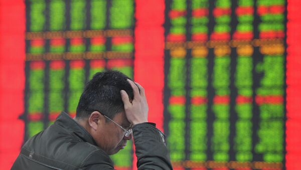 A stock investor gestures as he checks share prices at a securities firm in Fuyang, east China's Anhui province - Sputnik International