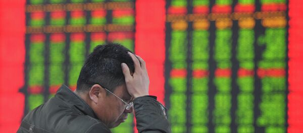A stock investor gestures as he checks share prices at a securities firm in Fuyang, east China's Anhui province A stock investor gestures as he checks share prices at a securities firm in Fuyang, east China's Anhui province - Sputnik International