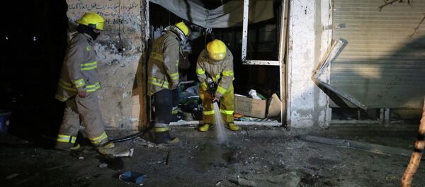 Afghan firefighters spray water at the site of a suicide attack targeting parliamentarian Gul Pacha Mujedi in Kabul, Afghanistan, Sunday, March 29, 2015 Afghan firefighters spray water at the site of a suicide attack targeting parliamentarian Gul Pacha Mujedi in Kabul, Afghanistan, Sunday, March 29, 2015 - Sputnik International