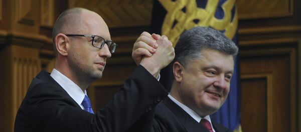 Ukraine's President Petro Poroshenko, right, celebrates with Arseniy Yatsenyuk after Yatsenyuk was appointed as Prime Minister during the opening first session of the Ukrainian parliament in Kiev Ukraine's President Petro Poroshenko, right, celebrates with Arseniy Yatsenyuk after Yatsenyuk was appointed as Prime Minister during the opening first session of the Ukrainian parliament in Kiev - Sputnik International