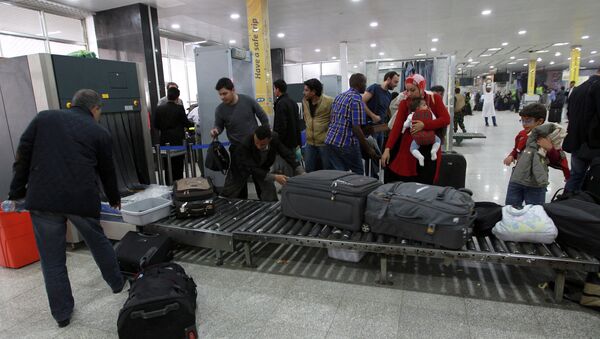 Travelers pass through security at Sanaa International Airport as hundreds of foreigners were evacuated from the Yemeni capital due to security reasons on March 28, 2015 - Sputnik International