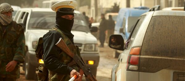 A rebel fighter wears a traffic police's hat while controlling traffic in Idlib city, after they took control of the area March 29, 2015 A rebel fighter wears a traffic police's hat while controlling traffic in Idlib city, after they took control of the area March 29, 2015 - Sputnik International