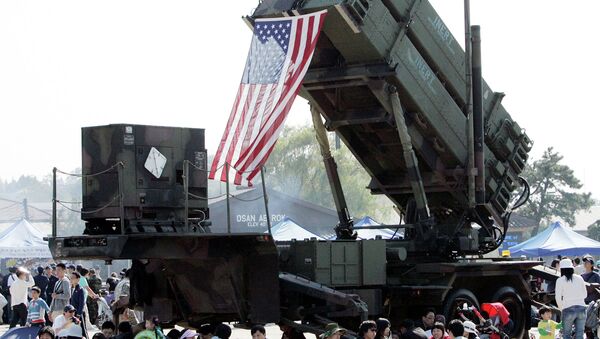 South Korean visitors shelter from the sun under the shadow of a U.S. Surface-to Air missile Patriot launcher during Air Power Day at the U.S. airbase in Osan, south of Seoul, South Korea - Sputnik International