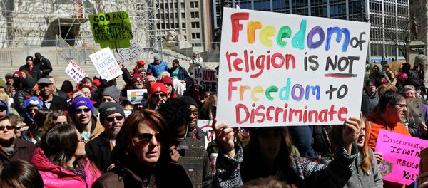 Demonstrators gather at Monument Circle to protest a controversial religious freedom bill recently signed by Governor Mike Pence during a rally in Indianapolis March 28, 2015 - Sputnik International