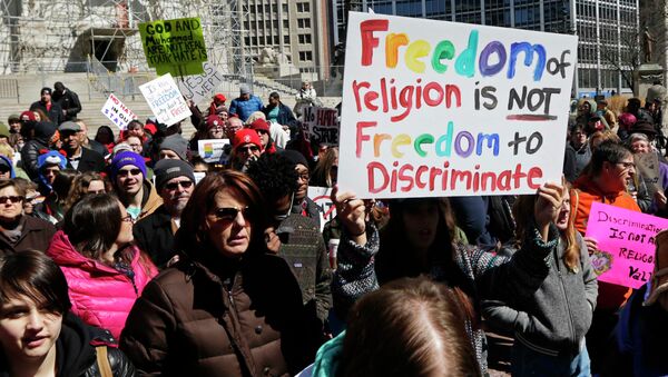 Demonstrators gather at Monument Circle to protest a controversial religious freedom bill recently signed by Governor Mike Pence during a rally in Indianapolis March 28, 2015 - Sputnik International