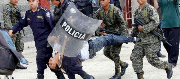 Police and military personnel carry away an injured protester in Tegucigalpa, Honduras. Police and military personnel carry away an injured protester in Tegucigalpa, Honduras. - Sputnik International