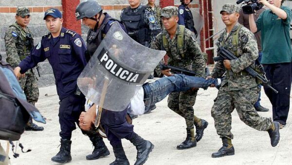 Police and military personnel carry away an injured protester in Tegucigalpa, Honduras. - Sputnik International