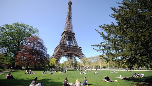 People enjoy the sunny spring weather near the Eiffel tower in Paris - Sputnik International