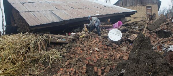 A Kashmiri villager inspects a damaged house following landslides A Kashmiri villager inspects a damaged house following landslides - Sputnik International