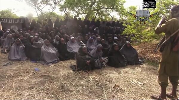  This Monday, May 12, 2014, file image taken from video by Nigeria's Boko Haram terrorist network, shows the alleged missing girls abducted from the northeastern town of Chibok. Islamic extremists in Nigeria have seized Chibok, forcing thousands of residents to flee the northeastern town from which the insurgents kidnapped nearly 300 schoolgirls in April. - Sputnik International