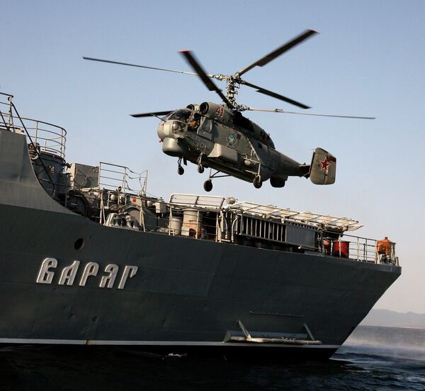 Anti-submarine helicopter Ka-27 hovering over the Guards' missile cruiser Varyag Anti-submarine helicopter Ka-27 hovering over the Guards' missile cruiser Varyag - Sputnik International