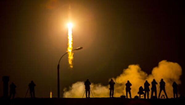Media photograph the Soyuz TMA-16M spacecraft is seen as it launches to the International Space Station with Expedition 43 NASA Astronaut Scott Kelly, Russian Cosmonauts Mikhail Kornienko, and Gennady Padalka of the Russian Federal Space Agency (Roscosmos) onboard Saturday, March 28, 2015, Kazakh time (March 27 Eastern time) from the Baikonur Cosmodrome in Kazakhstan. As the one-year crew, Kelly and Kornienko will return to Earth on Soyuz TMA-18M in March 2016 - Sputnik International