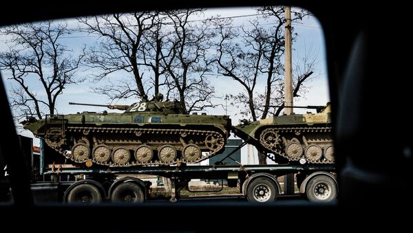 Armour Personnel Carriers loaded on a truck in the eastern Ukrainian city of Donetsk. - Sputnik International