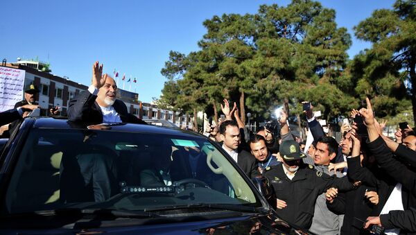 Iranian Foreign Minister Mohammad Javad Zarif, who is also Iran's top nuclear negotiator, waves to his well wishers upon arrival at the Mehrabad airport in Tehran, Iran, from Lausanne, Switzerland, Friday, April 3, 2015 - Sputnik International