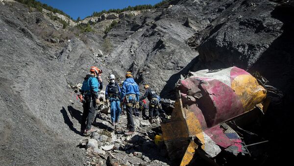 Rescue workers and investigators, seen in this picture made available to the media by the French Interior Ministry April 1, 2015, work near debris from wreckage at the crash site of a Germanwings Airbus A320, near Seyne-les-Alpes - Sputnik International