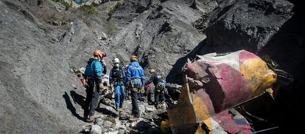Rescue workers and investigators, seen in this picture made available to the media by the French Interior Ministry April 1, 2015, work near debris from wreckage at the crash site of a Germanwings Airbus A320, near Seyne-les-Alpes - Sputnik International