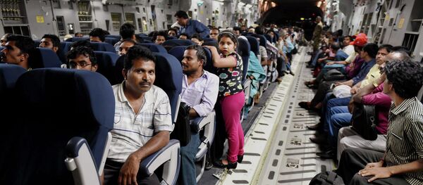 Indians evacuated from Yemen sit inside the Indian Air Force C17 Globemaster aircraft upon their arrival at Chhatrapati Shivaji International Airport in Mumbai, India, Thursday, April 2, 2015 - Sputnik International