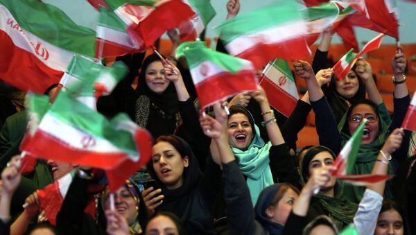 Iranian women wave Iranian flags during a ceremony of farewell for their national soccer team ahead of the 2014 World Cup in Brazil - Sputnik International