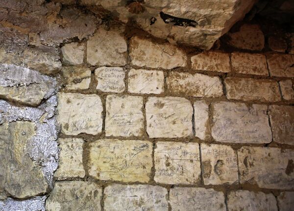 In this photo taken Friday Feb. 20, 2015, names are engraved in a former chalk quarry, at the Cite Souterraine, Underground City, in Naours, northern France In this photo taken Friday Feb. 20, 2015, names are engraved in a former chalk quarry, at the Cite Souterraine, Underground City, in Naours, northern France - Sputnik International
