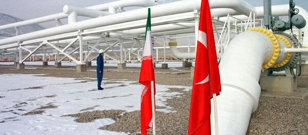 An Iranian worker stands in front of gas pipelines next to the flags of Turkey (R) and Iran An Iranian worker stands in front of gas pipelines next to the flags of Turkey (R) and Iran - Sputnik International