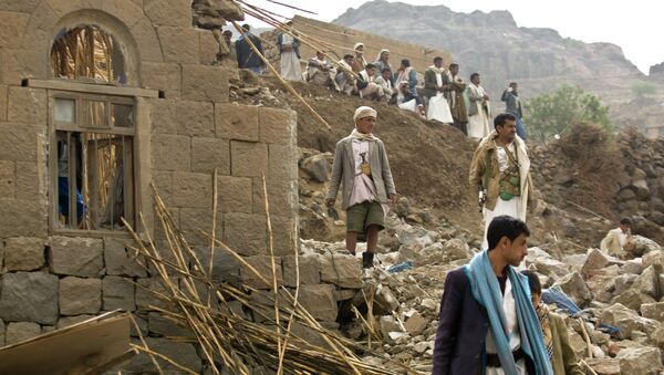 In this Saturday, April 4, 2015 file photo, Yemenis stand amid the rubble of houses destroyed by Saudi-led airstrikes in a village near Sanaa, Yemen - Sputnik International