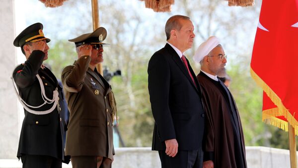 Iran's President Hassan Rouhani (R) stands with Turkish President Recep Tayyip Erdogan (2R) during an official welcoming ceremony following the latter's arrival at the Saadabad Palace in Tehran on April 7, 2015 - Sputnik International
