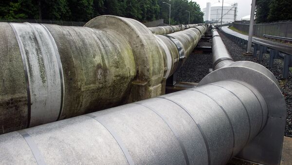 Transfer pipes carry liquified natural gas to and from a holding tank, seen in background, at Dominion Energy's Cove Point LNG Terminal in Lusby, Md., Thursday, June 12, 2014 - Sputnik International