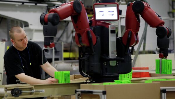 A technician works with Baxter, an adaptive manufacturing robot created by Rethink Robotics at The Rodon Group manufacturing facility, Tuesday, March 12, 2013, in Hatfield, Pa. - Sputnik International