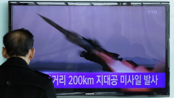 A South Korean man watches a TV news program showing the file footage of the missile launch conducted by North Korea. - Sputnik International