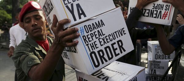 A Venezuela's soldier carries boxes containing signatures to ask U.S. President Barack Obama to lift sanctions against a group of Venezuelan army members before a rally at Miraflores Palace in Caracas A Venezuela's soldier carries boxes containing signatures to ask U.S. President Barack Obama to lift sanctions against a group of Venezuelan army members before a rally at Miraflores Palace in Caracas - Sputnik International