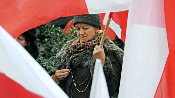 A woman seen between Polish national flags - Sputnik International