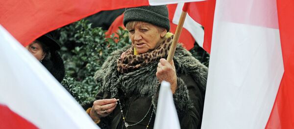 A woman seen between Polish national flags A woman seen between Polish national flags - Sputnik International