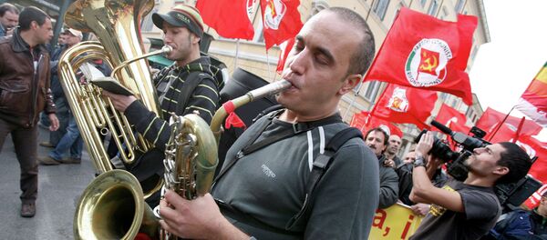 People play music as others hold Italian Communist Refoundation party flags during a demonstration in downtown Rome, Italy. (File) People play music as others hold Italian Communist Refoundation party flags during a demonstration in downtown Rome, Italy. (File) - Sputnik International