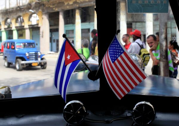 Miniature flags representing Cuba and the United States are displayed on the dash of an American classic car in Havana, Cuba. Miniature flags representing Cuba and the United States are displayed on the dash of an American classic car in Havana, Cuba. - Sputnik International