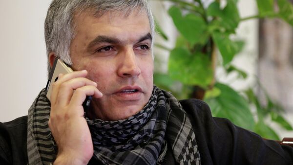 Nabeel Rajab, one of Bahrain's best-known human rights activists, gets word from his lawyer on his appeal at his home in Bani Jamra, Bahrain, Sunday, March 15, 2015. - Sputnik International