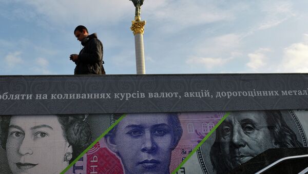A man stands next to an advertising placard showing British pounds, US dollars and Ukrainian hryvnia banknotes in the Ukrainian capital Kiev, file photo. - Sputnik International