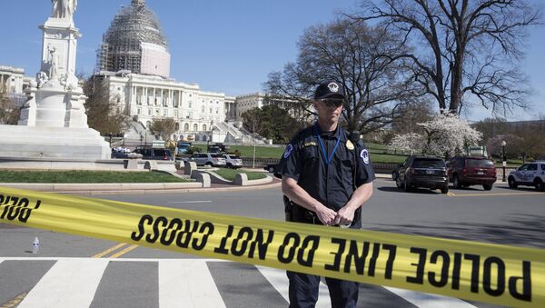 Police guard the U.S. Capitol grounds after a shooting took place, in Washington April 11, 2015 - Sputnik International