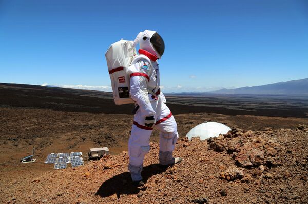 In this June 4 2013 photo provided by the University of Hawaii, research space scientist Oleg Abramov walks outside simulated Martian base at Mauna Loa, Hawaii - Sputnik International