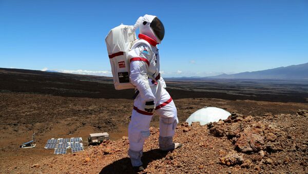 In this June 4 2013 photo provided by the University of Hawaii, research space scientist Oleg Abramov walks outside simulated Martian base at Mauna Loa, Hawaii - Sputnik International