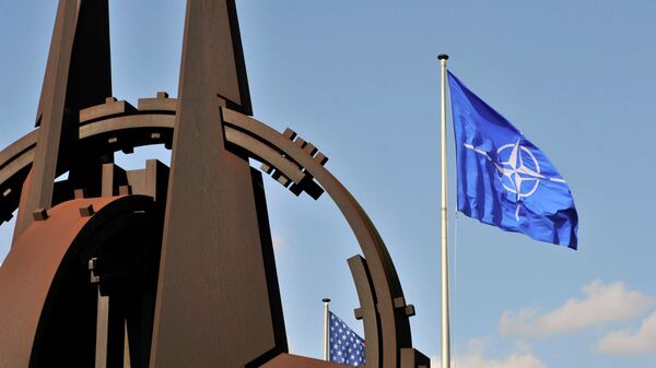 A picture taken on March 2, 2014 shows the NATO flag in the wind at the NATO headquarters in Brussels. - Sputnik International