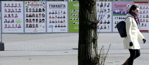 A woman walks past campaign posters of candidates in the Finnish Parliamentary elections put up along a street in Helsinki, April 10, 2015 A woman walks past campaign posters of candidates in the Finnish Parliamentary elections put up along a street in Helsinki, April 10, 2015 - Sputnik International