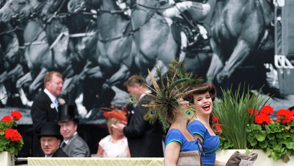 Two members of a choral group laugh as they walk near the parade ring on the third day of the Royal Ascot horse racing meeting, which is traditionally known as Ladies Day, at Ascot, England, Thursday, June, 19, 2014 - Sputnik International