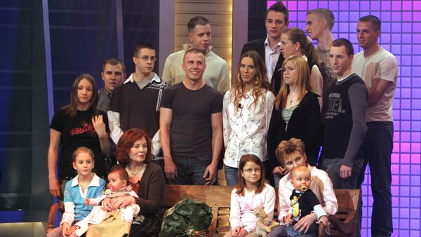 This photo taken on December 11, 2005 shows then 55-old Annegret Raunigk (1st row, 2ndL), posing with her youngest daugher Lelia (on her knees) and other children and grand-children in Cologne as guest in a German channel RTL show «2005! People, Photos, Emotions». File photo - Sputnik International