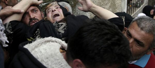 Mourners grieve during the funeral of Ziyad Awad during his funeral in Beit Ummar, West Bank, Friday, April 10, 2015 Mourners grieve during the funeral of Ziyad Awad during his funeral in Beit Ummar, West Bank, Friday, April 10, 2015 - Sputnik International