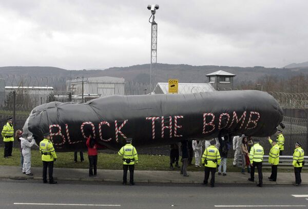 Campaigners hold an inflatable during a protest in front of the Trident submarine fleet naval base in Faslane, Scotland - Sputnik International