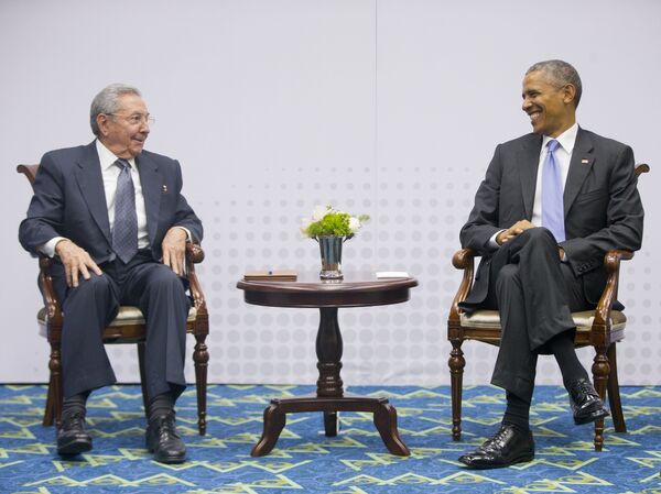 US President Barack Obama, right, smiles as he looks over towards Cuban President Raul Castro, left, during their meeting at the Summit of the Americas in Panama City - Sputnik International